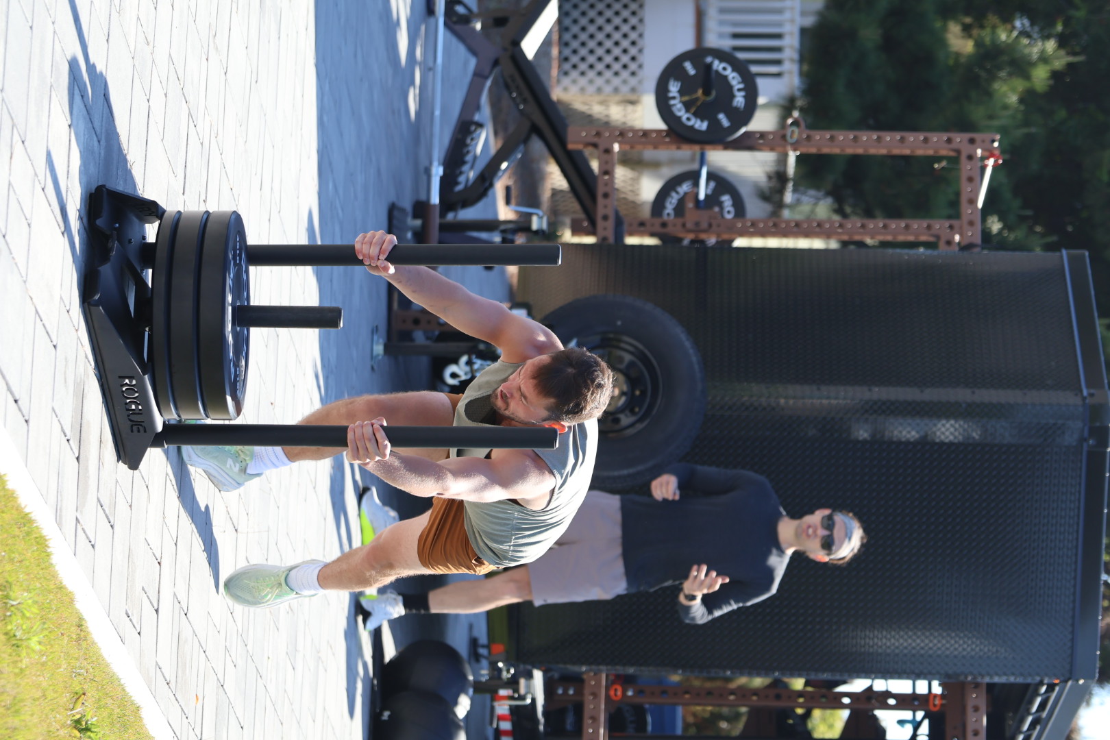Sled push coaching at the mobile gym trailer