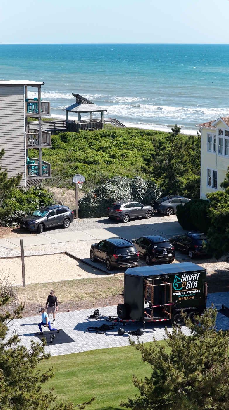 Sweat & Sea mobile gym trailer set up with ocean view